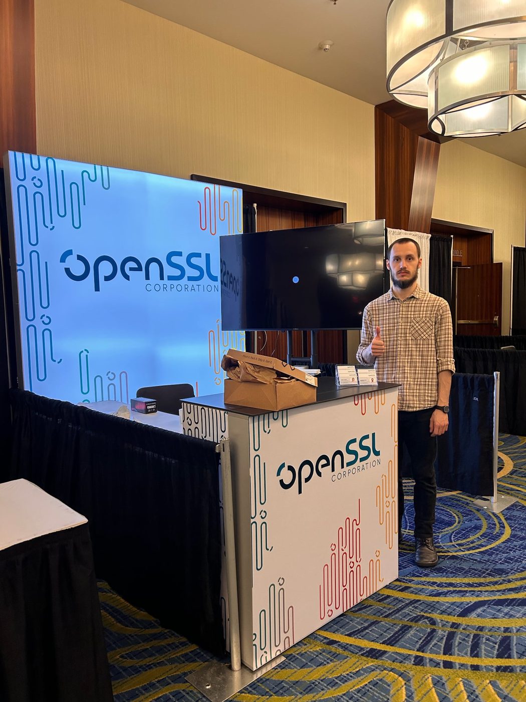 Thumbs up in front of the finished OpenSSL booth